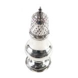 A silver pepper pot, of bellied form with domed pierced lid, urn finial and circular foot, marks rub