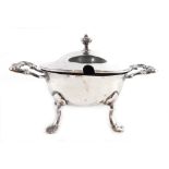 An Edwardian silver mustard pot, of oval form with scroll handles, on quadruple hoof feet with urn f