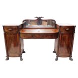 An early 19thC bow fronted twin pedestal mahogany sideboard, with panels to the frieze, on two pedes