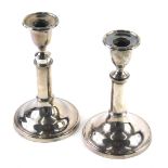 A pair of early 20thC silver plated telescopic candlesticks, with urn dish holders, articulated stem