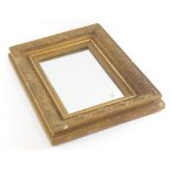 A small gilt gesso rectangular mirror, the frame decorated with shells, leaves, etc., 28cm x 37cm.