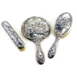 A harlequin Elizabeth II silver three piece dressing table set, comprising clothes brush, hairbrush