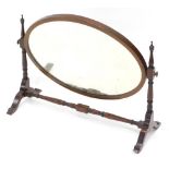 A mahogany dressing table mirror, with oval plate on shaped supports, 64cm wide.