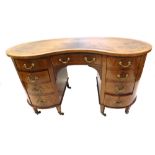 An Edwardian mahogany boxwood and ebony strung kidney shaped desk, with overall satinwood crossbandi