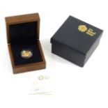A Britannia 22ct gold ten pound proof coin, in box with outer case and paperwork.