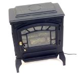 An electric mock wood burning stove, with single astragal glazed door, on shaped feet, in black iron