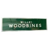 A Wills Woodbines tin advertising sign, in green and white, 43cm x 150cm.