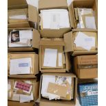 Eleven large boxes of stamps mounted on envelopes, for processing.