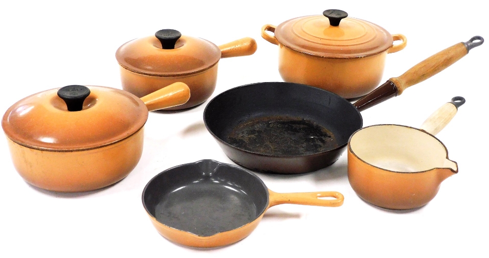 A group of Le Creuset lidded saucepans, in brown, comprising two saucepans, 20cm diameter and 18cm d