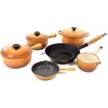 A group of Le Creuset lidded saucepans, in brown, comprising two saucepans, 20cm diameter and 18cm d