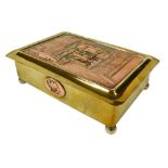 An early 20thC copper and brass twin division cigarette box, embossed to the lid with a 12000 tonne