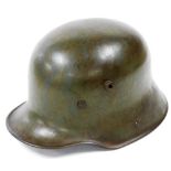 A German World War I M16 helmet, circa 1916, bears side mark Si 66 and heating lot code Bi 717, inte