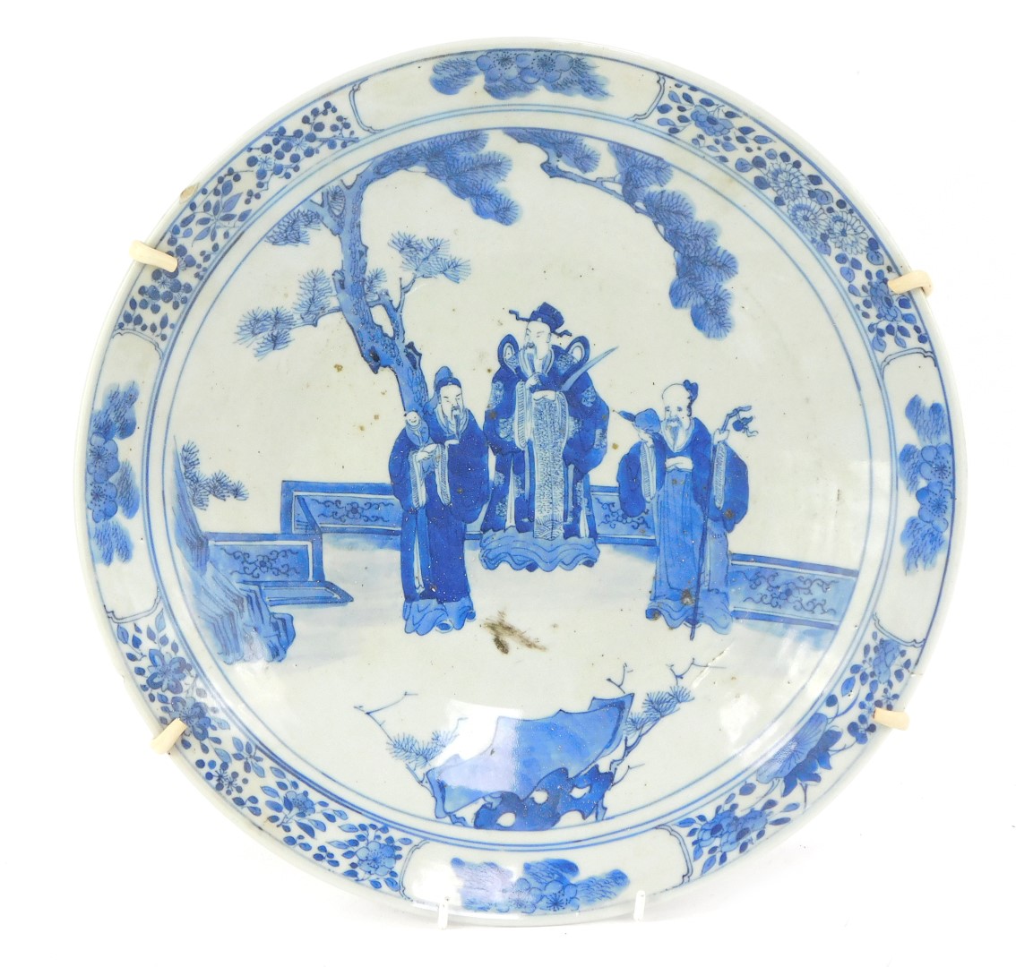 A 19thC Japanese blue and white charger, with Chinese figures with a floral border, 34cm diameter.