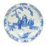 A 19thC Japanese blue and white charger, with Chinese figures with a floral border, 34cm diameter.