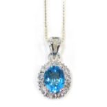 A silver blue zircon and CZ set cluster pendant, the basket setting with oval blue zircon surrounded