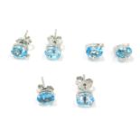 Three pairs of silver and blue zircon set studs, comprising two oval plain studs and a pair of half