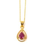 A ruby pendant and chain, the tear drop shaped pendant set with central faceted stone, on a fine lin