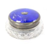 An Elizabeth II silver and enamel dressing table jar, the circular silver top with royal blue enamel
