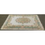 An Indian carpet, on a cream ground with central floral design, 280cm x 179cm.