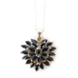 A Shipton & Co Jewellery Company silver pendant and chain, the layered blue stone set pendant on a f