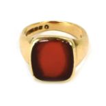 A 9ct gold orange agate gentleman's signet ring, with a rectangular set stone in rub over setting, s