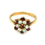 A 9ct gold cluster ring, set with layers of garnets and opals in a raised basket, size N, 2.7g all i