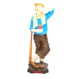 A plastic Tintin advertising model, depicting Tintin frowning and leaning on a baseball bat, on step