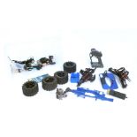 A group of remote control car parts, wheels and controllers.