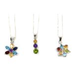 Three silver multi stone set necklaces, comprising two cluster pendants formed as flowers, and a thr