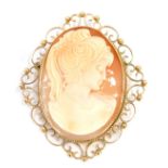 A late 19thC shell cameo brooch, depicting a maiden in flowing dress, quarter profile, with scroll o