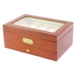 A watch display case, in a walnut finish with inserts for ten wristwatches and a pull out drawer, wi