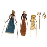 A group of Eastern hardwood puppets, each of varying design with heavy gilt painted detail, some wit