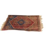 A Persian rug, on a blue, red and cream ground, with central medallion and four borders, 97cm x 63cm