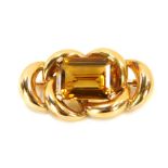 A citrine bar brooch, set with rectangular cut citrine, with border of interlinked scrolls, on singl