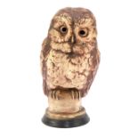 A Chelsea pottery figure of an owl, on socle, printed marks beneath, 33cm high.