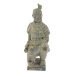 A terracotta style Chinese grave figure, kneeling in flowing robes, on a shaped base, 22cm high.