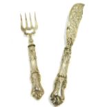 A set of Victorian silver fish servers, comprising knife and fork, with heavy foliate scroll loaded