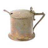A Victorian silver mustard pot, with a shaped thumb piece clasp on plain body with a buckle crest, L