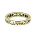 An eternity ring, set with imitation diamonds, in a white metal setting, unmarked, size M.