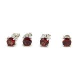 Two pairs of stud earrings, each in white metal baskets, stamped 925, set with red stone, 4.2g all i