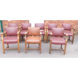 A set of eight oak framed carver chairs, one tan and seven maroon studded leatherette seat, 84cm hig