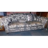 A Duresta style two seater sofa, in charcoal grey with floral sprays, 230cm wide, 70cm high, 100cm d