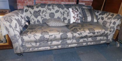 A Duresta style two seater sofa, in charcoal grey with floral sprays, 230cm wide, 70cm high, 100cm d
