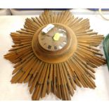 A gilt metal sunburst clock with Buren movement and Roman numeric dial.