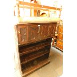 A tapestry duet stool, and an oak bookcase with cupboard top. (2) The upholstery in this lot does no