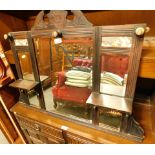 A 1920's oak hanging rack, with mirrored shelf panels and prints of nude ladies.