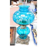 A blue glass oil lamp table lamp.