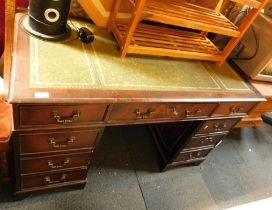 A reproduction pedestal desk, with three drawers to each pedestal, green leather inset top, 72cm hig