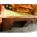 A reproduction pedestal desk, with three drawers to each pedestal, green leather inset top, 72cm hig