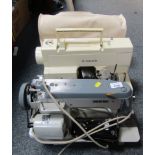 A Dorina 16 electric sewing machine with cover, and Singer sewing machine with cover. (2) WARNING!